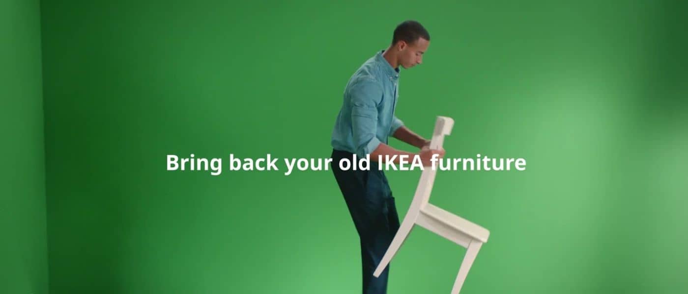 Young man moving a white IKEA dining room chair