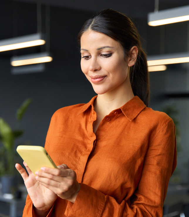 Woman in orange shirt browsing phone