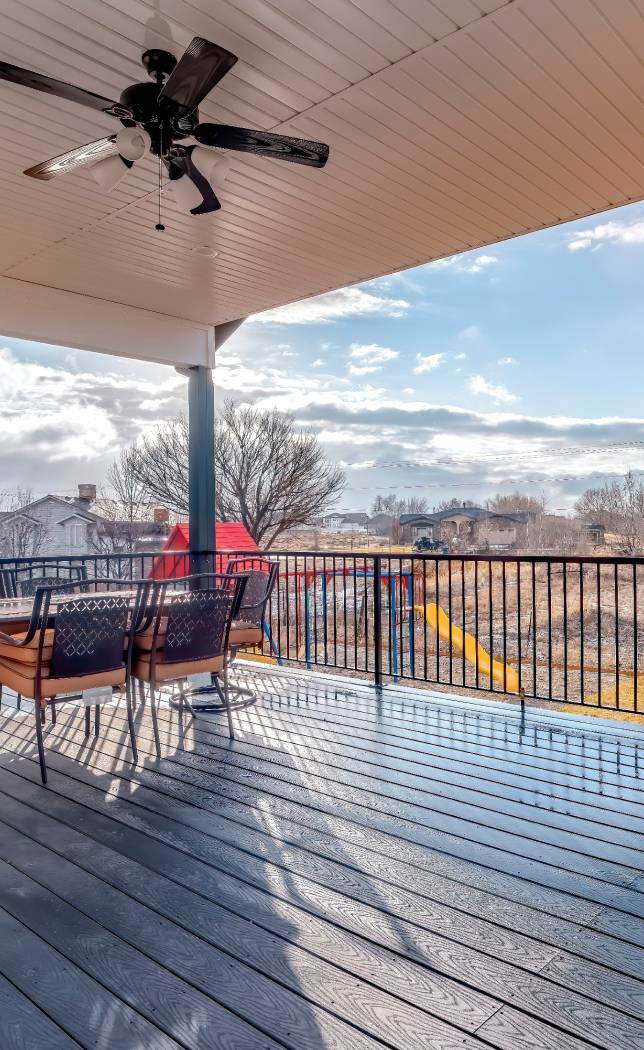 Decking with table and chairs with metal railing
