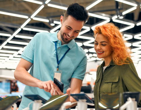 Female customer talking to employee in tech store